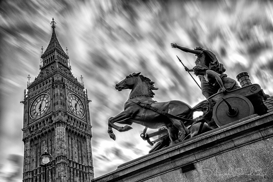 Long exposure of clouds with Big Ben and horse statue.