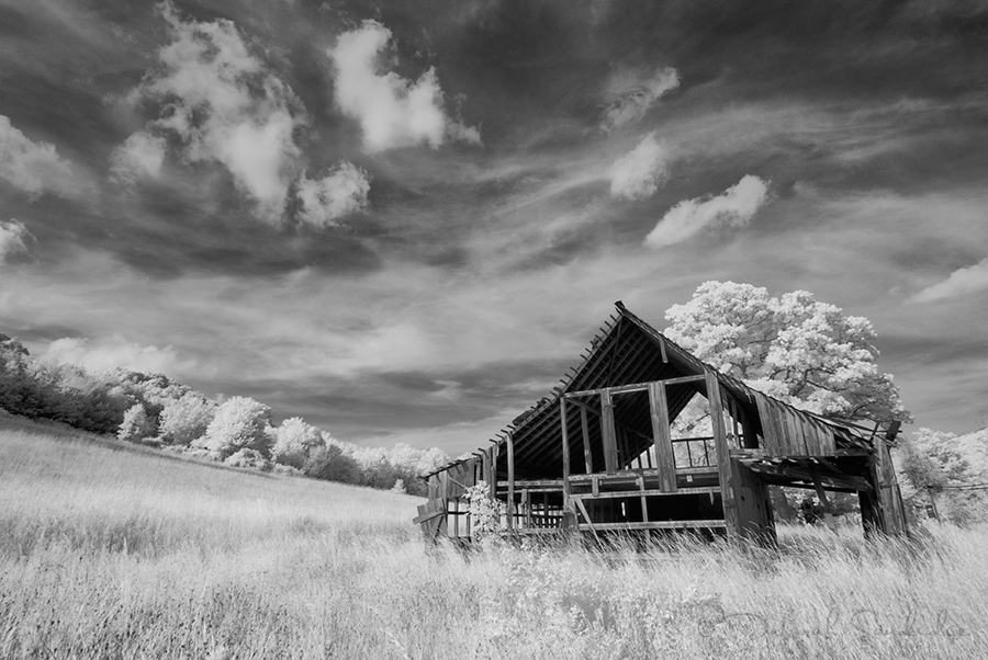 Old barn losing boards photographed in North Carolina in infrared.