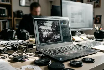Field Home office writing setup with laptop displaying a flat, infrared raw file